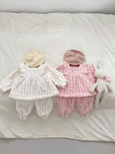 Detail view of winter velvet baby set with ruffled shoulders and floral lace collar