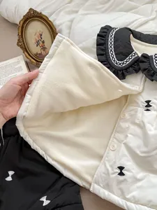 Detailed view of the soft fleece lining and lace collar on the floral winter coat