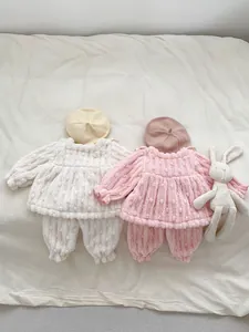 Detail view of thick winter plush baby loungewear set with soft polka dot texture and matching hat