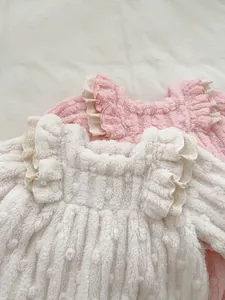 Detail of winter thermal kid's top with cable knit texture and lace ruffled collar