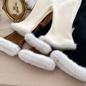 Close-up of ribbed knit flared leggings with soft faux fur trim and warm plush lining