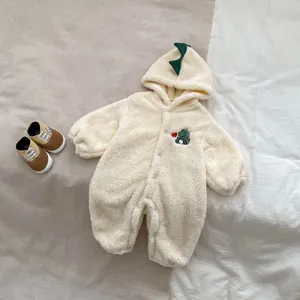 Detail of baby hooded romper with green dinosaur spikes and embroidered heart dinosaur