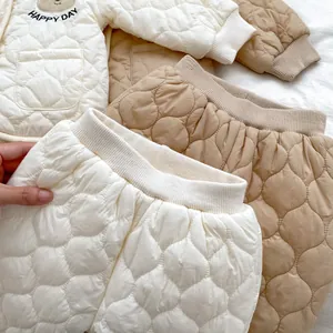 Detail of quilted baby winter suit showing bear pattern and ribbed cuffs for warmth