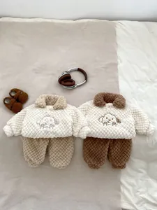 Detailed view of winter baby fleece set with cartoon embroidery and quilted texture