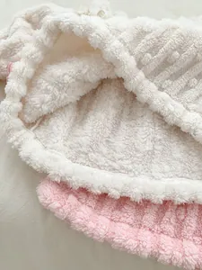 Close-up of soft pink and white thick polar fleece fabric texture for baby thermal wear