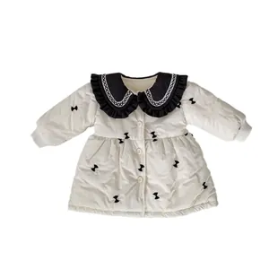 Infant girl quilted winter coat with black Peter Pan collar and bow patterns