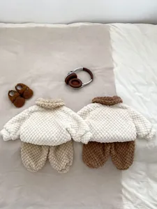 Detail of fleece baby winter sets featuring textured diamond patterns and cozy zip jackets