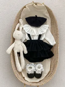 Elegant baby girl outfit with white ruffle collar top, black pinafore dress and beret