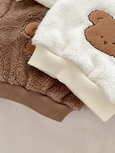 Detailed view of thick polar fleece kids outfits with cute bear embroidery appliques