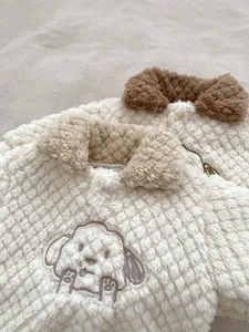 Detail of baby winter fleece set with pineapple texture and cute dog embroidery