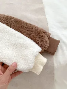 Detail of ribbed cuffs on thick polar fleece winter set for toddlers in brown and white