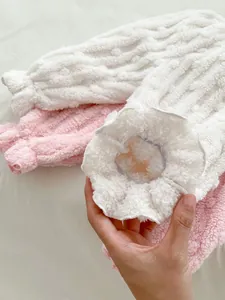 Close-up of thick winter fleece fabric with cable knit texture and elastic ribbed cuffs
