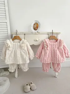 Detailed view of plush baby home set with ruffles and elastic cuffs in cream and pink