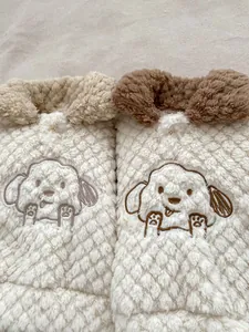 Close-up of baby winter fleece set with diamond quilted pattern and puppy embroidery