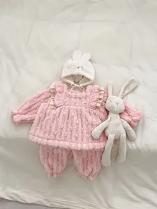 Detail of pink fleece baby home wear set with ruffle top, pants and bunny hat
