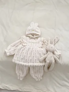 Detail of baby winter thermal set featuring 3D polka dot fleece fabric and bunny ear hat