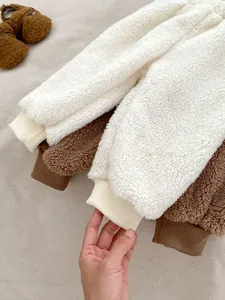 Close-up of thick fleece winter trousers with elastic ribbed cuffs for infants