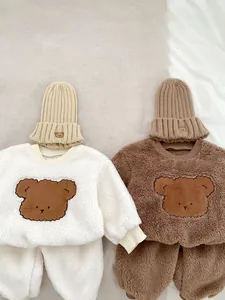 Detailed view of fleece winter toddler sets featuring cute bear embroidery and knit beanies