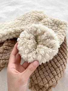 Close-up of thick fleece fabric detail on warm winter cartoon outfit for babies