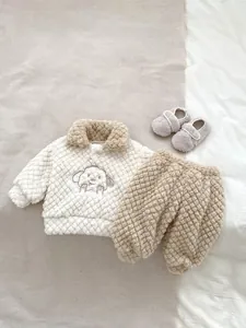Detail of baby winter fleece set with cute dog embroidery and cozy sherpa fabric texture