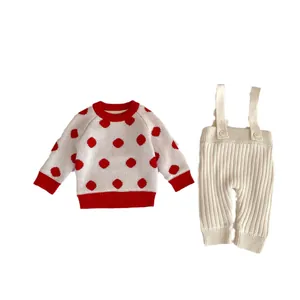 Ensemble d'hiver tricoté pour bébé avec pull à pois blancs et pantalon à bretelles ivoire