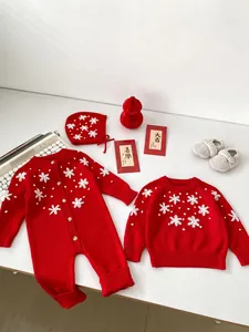 Detail of red knit baby romper set with white 3D flower embroidery and matching hat