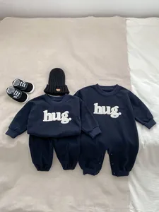 Navy baby romper and two-piece set with white towel-embroidered hug text details