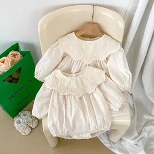 Detail of baby floral embroidery romper with lace trim and matching shoes set