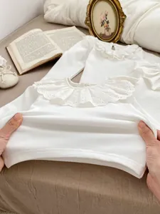 Baby girl white long sleeve top with vintage ruff collar and embroidery on a soft fabric
