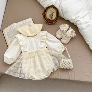 Detail of cream baby romper with rose lace skirt, matching beret and pearl handbag
