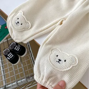 Cute cream waffle knit baby jogger pants with bear embroidery for spring comfort