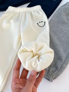 Detail of waffle knit fabric texture and elastic waistband on toddler jogger pants
