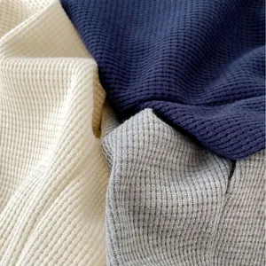 Soft waffle knit fabric stack in beige, navy, and grey for toddler jogger pants