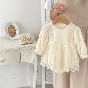 Infant cream waffle romper dress with lace trim and bows with matching soft shoes