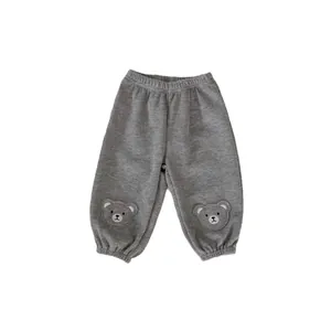 Grey waffle-knit kids trousers with cute bear embroidery and elasticated cuffs