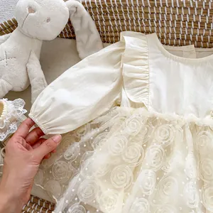 Princess style white baby bodysuit with floral tulle skirt and ruffle shoulders