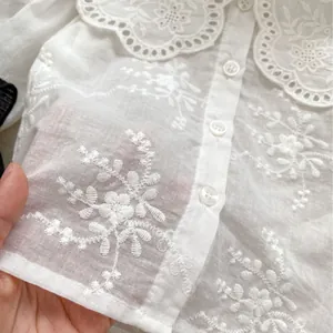 Camicia bianca neonata con grande colletto ricamato e delicati dettagli floreali traforati