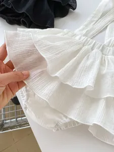 Detailed close-up of soft white muslin ruffles showing breathable crinkle fabric texture