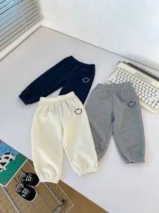 Toddler waffle knit joggers in navy, beige and grey with embroidered smiley face detail