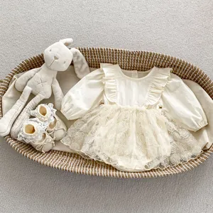 Close-up of baby girl romper featuring 3D rose tulle skirt and matching lace bow shoes