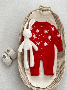 Red knitted baby romper with white flower embroidery and plush toy decorations