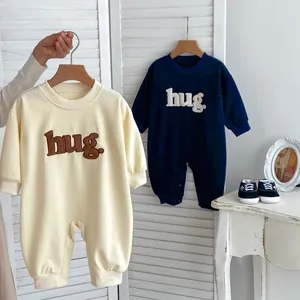Baby long sleeve cotton bodysuit featuring minimalist hug embroidery in cream and navy