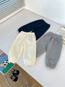 Flat lay of boys waffle knit joggers in navy, cream and grey with elastic waist