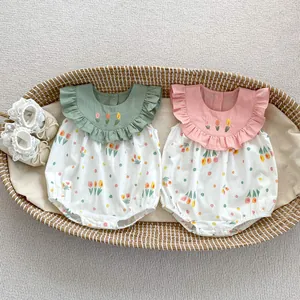 Vue à plat de bodys pour bébé avec broderie tulipe et chaussures en dentelle