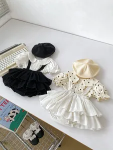 Flat lay of vintage style baby girls' collar shirts and ruffle strap skirt sets