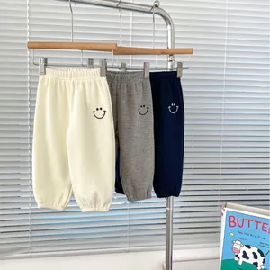 Three-pack waffle knit boys joggers in cream, grey and navy with smile embroidery