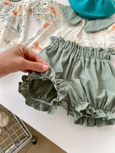 Detail view of baby cotton shorts with elastic ruffles and cute fox print shirt set