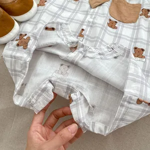 Detail of baby romper snap fasteners and soft cotton checked fabric texture