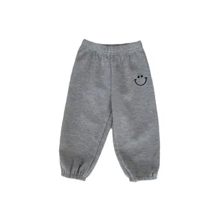 Gray boys waffle knit joggers with elastic waist and smile face embroidery on the leg