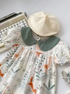 Detail of baby floral bodysuit with forest animal prints and green Peter Pan collar